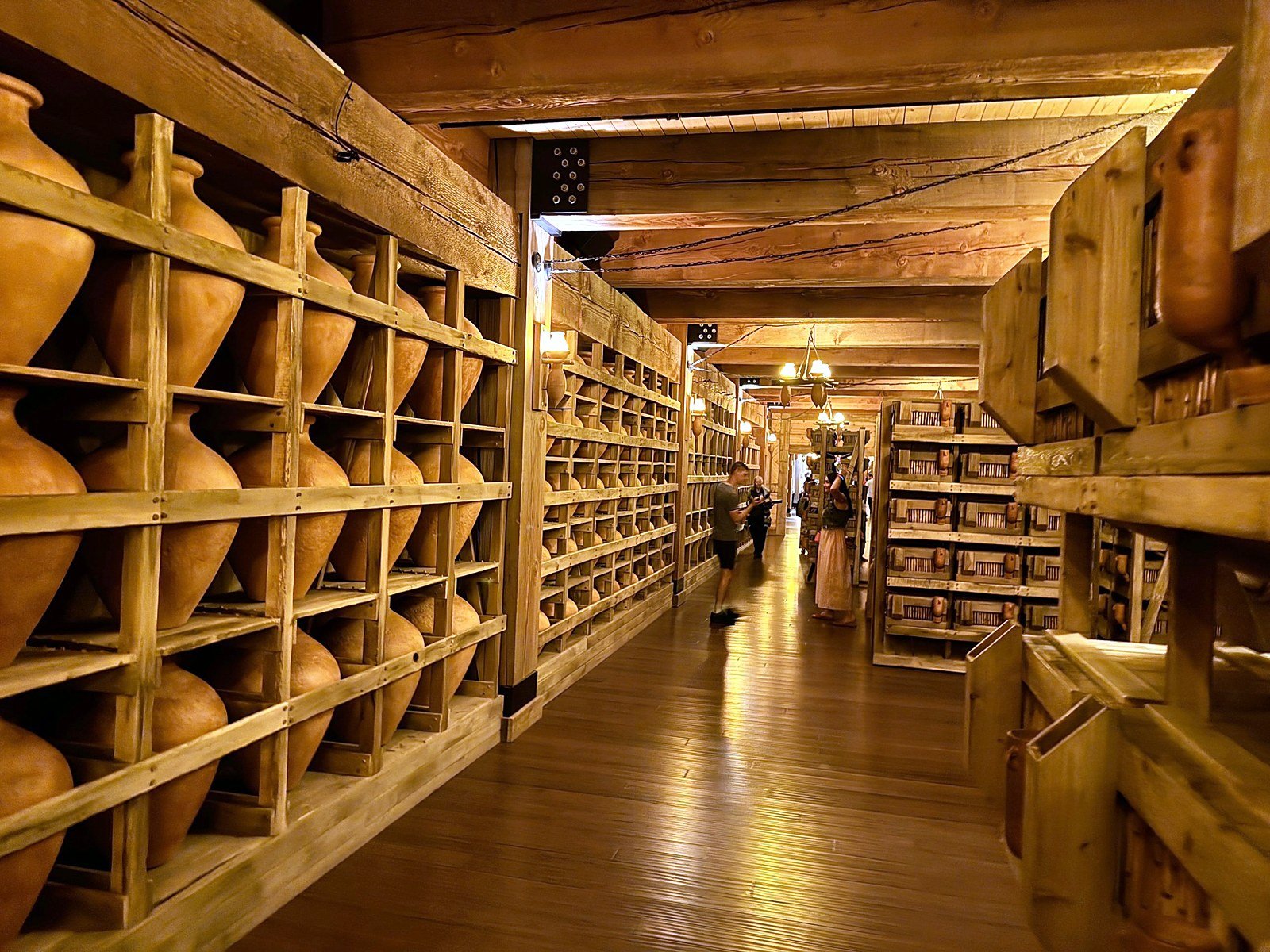 Long timber corridor lined with clay jars inside the Ark Encounter