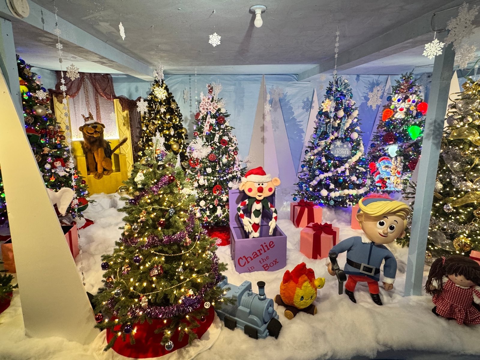 Charlie-in-the-Box and Hermey the elf with a toy train and campfire