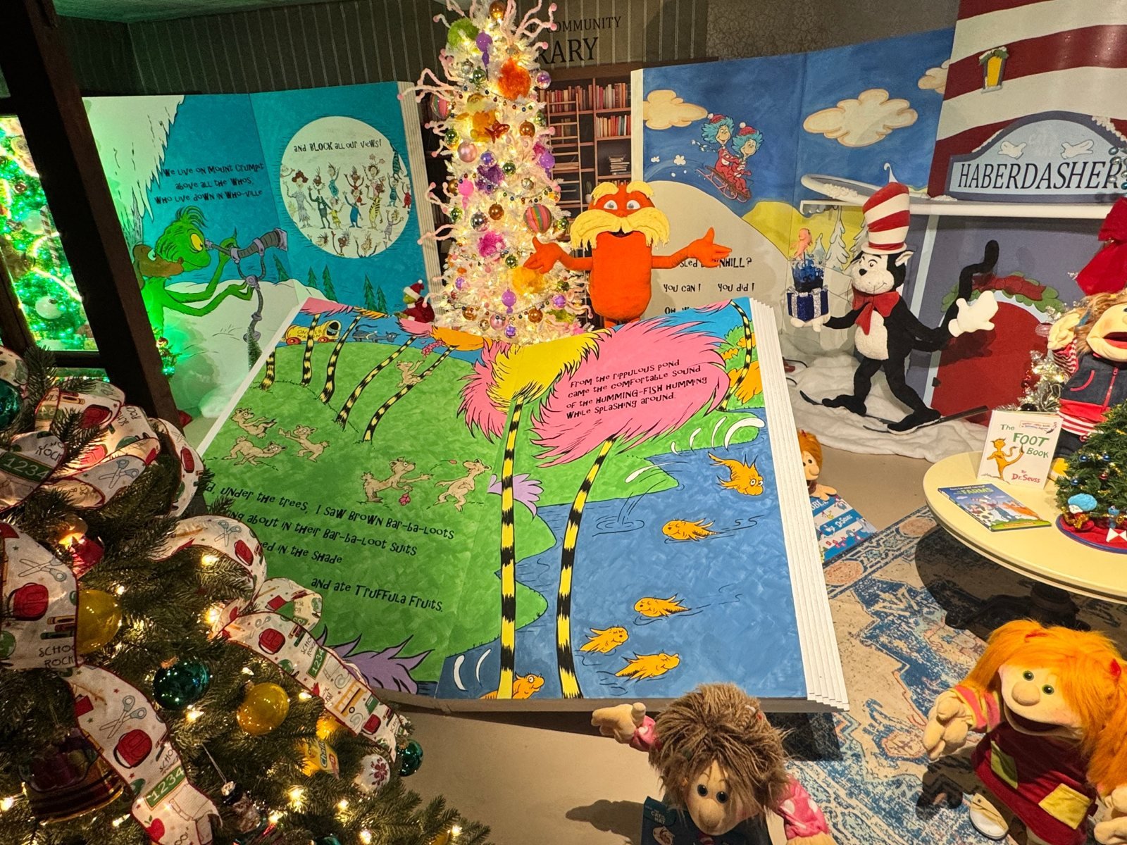 The Lorax and Cat in the Hat with a giant storybook in the Dr. Seuss library scene